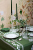 rectangular green embroidered tablecloth with white flowers with candles