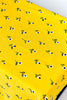 rectangular yellow tablecloth with white daisies