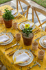 rectangular yellow tablecloth with white daisies with tablesetting