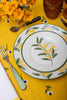 rectangular yellow tablecloth with white daisies with floral plates