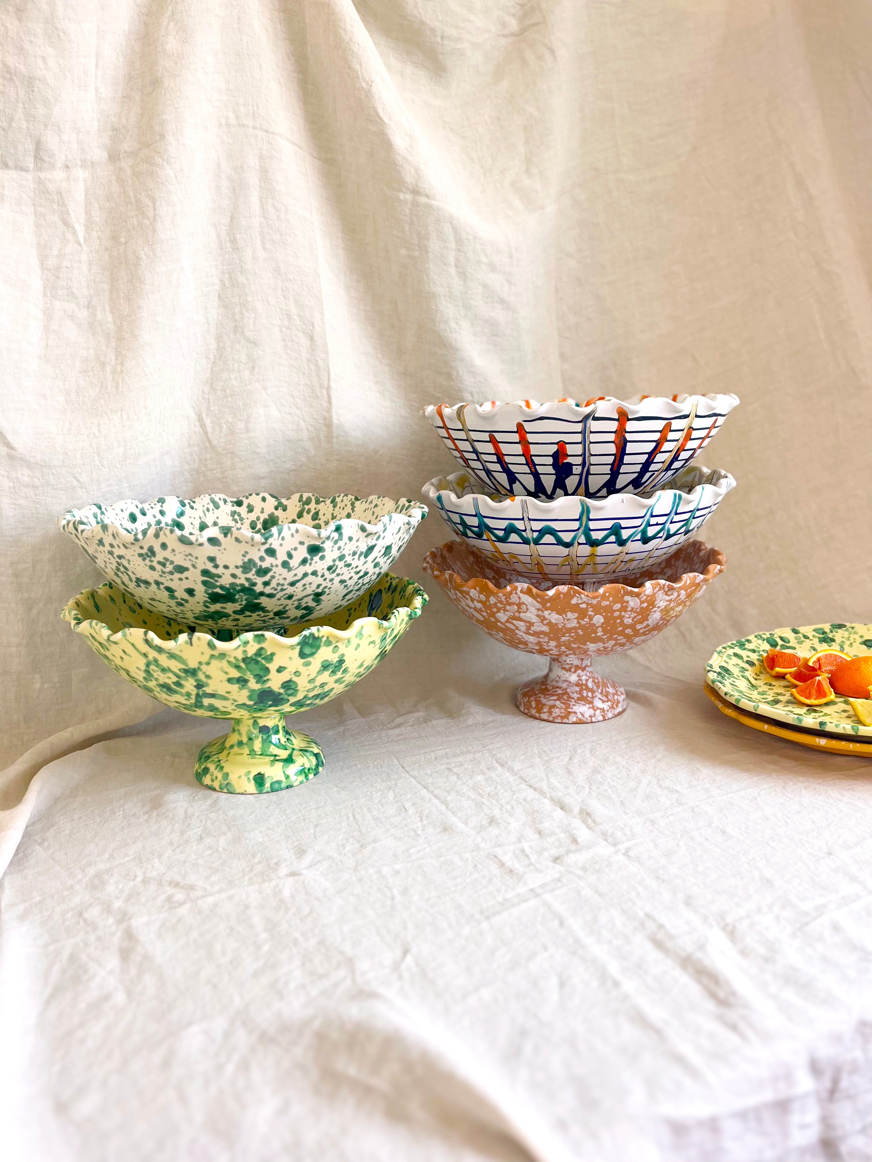 group of scallop edged compote bowls on white cloth