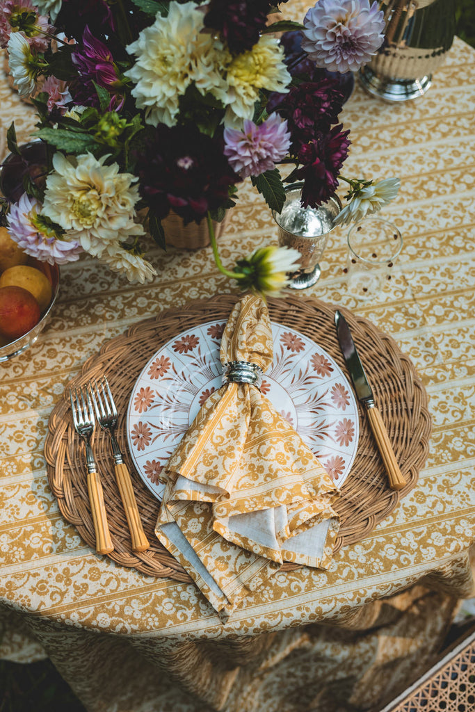 striped linen napkins in yellow melograno pattern with woven placemat