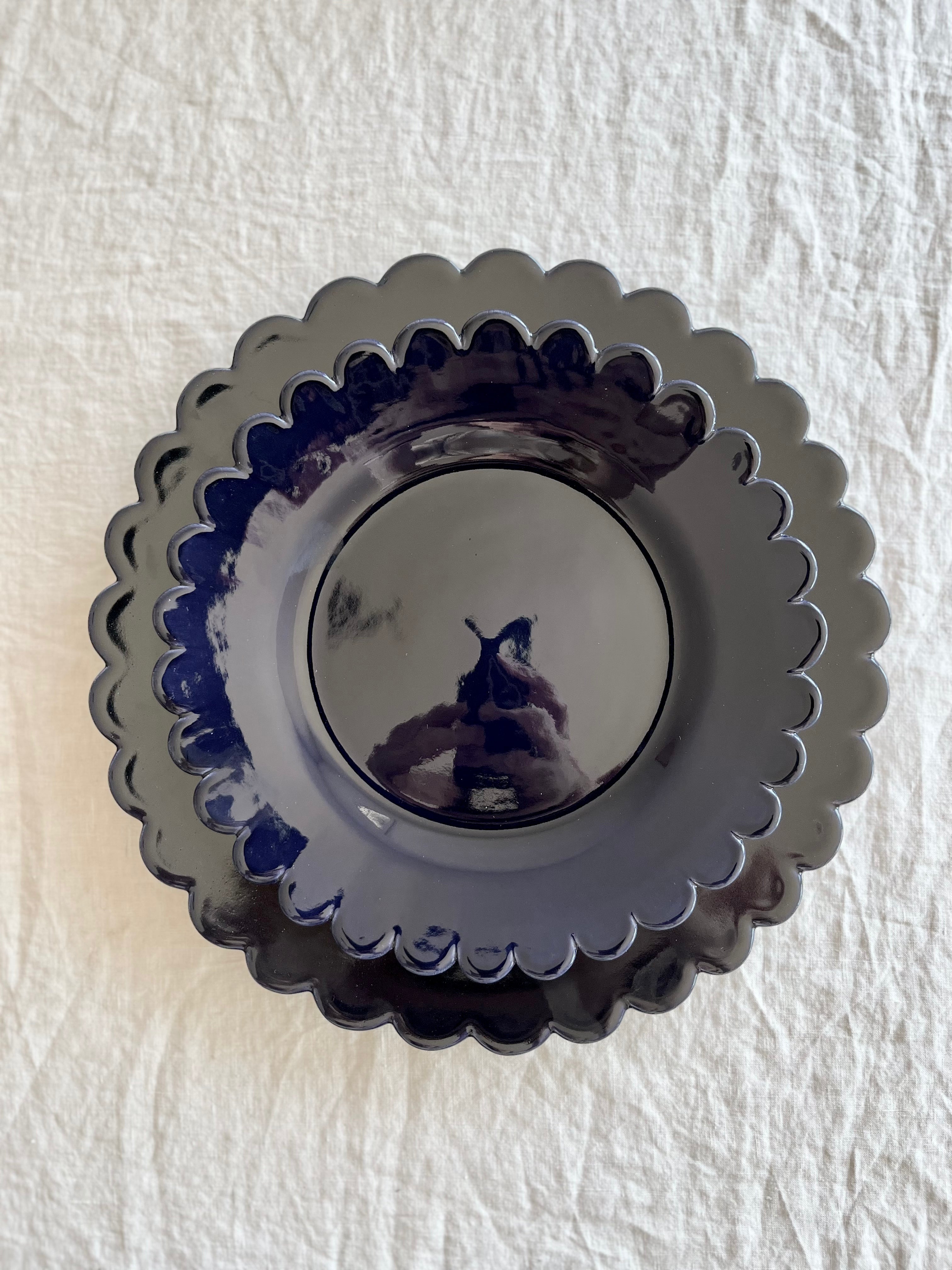 dark blue dinner plate with scalloped edge with salad plate