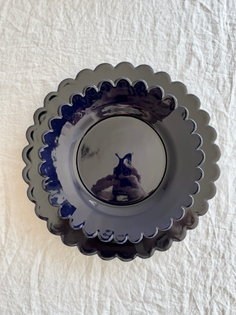 dark blue dinner plate with scalloped edge with salad plate