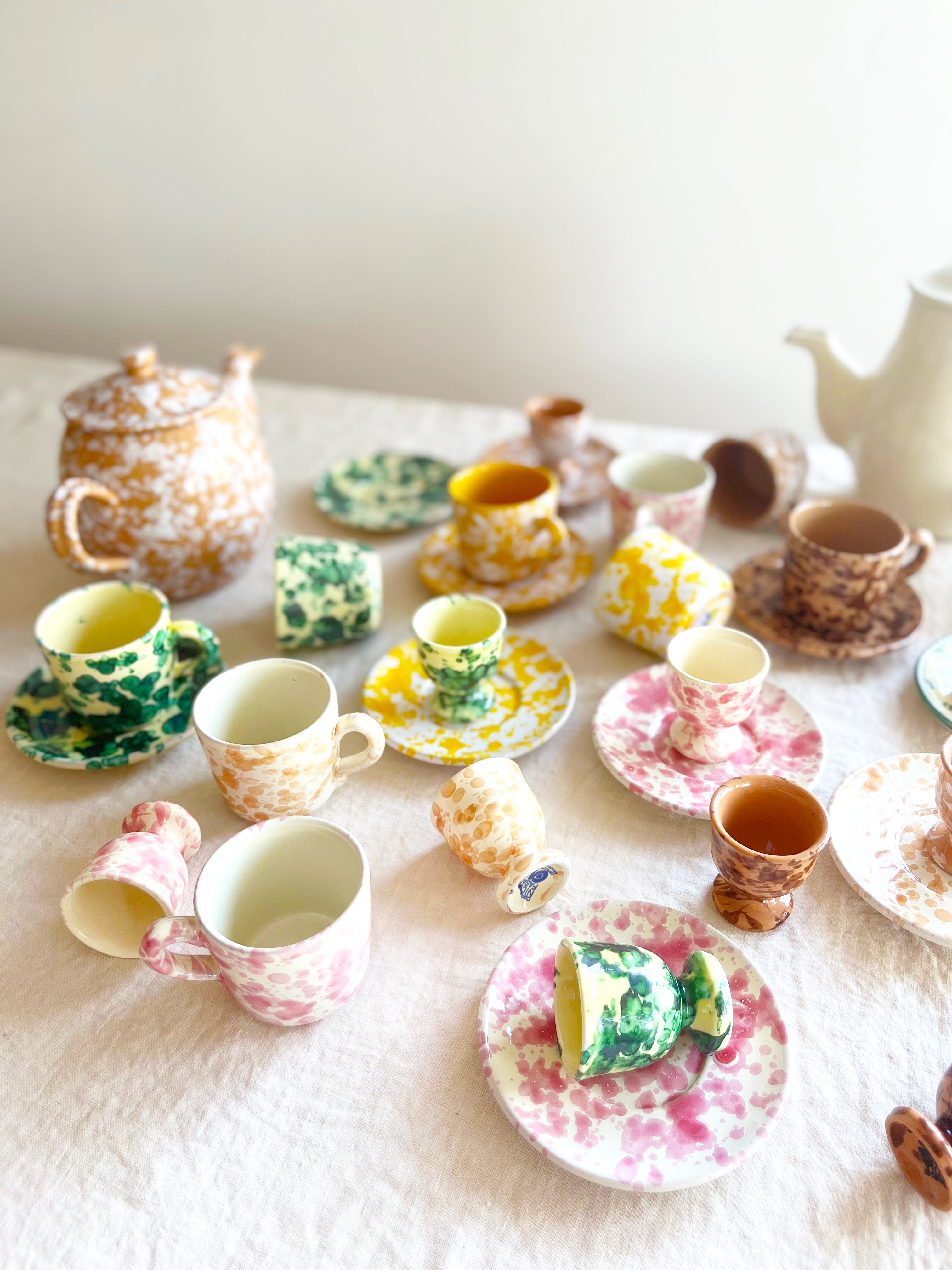 fasano egg cups with splatter pattern in sienna grouped with coffee pots and espresso cups