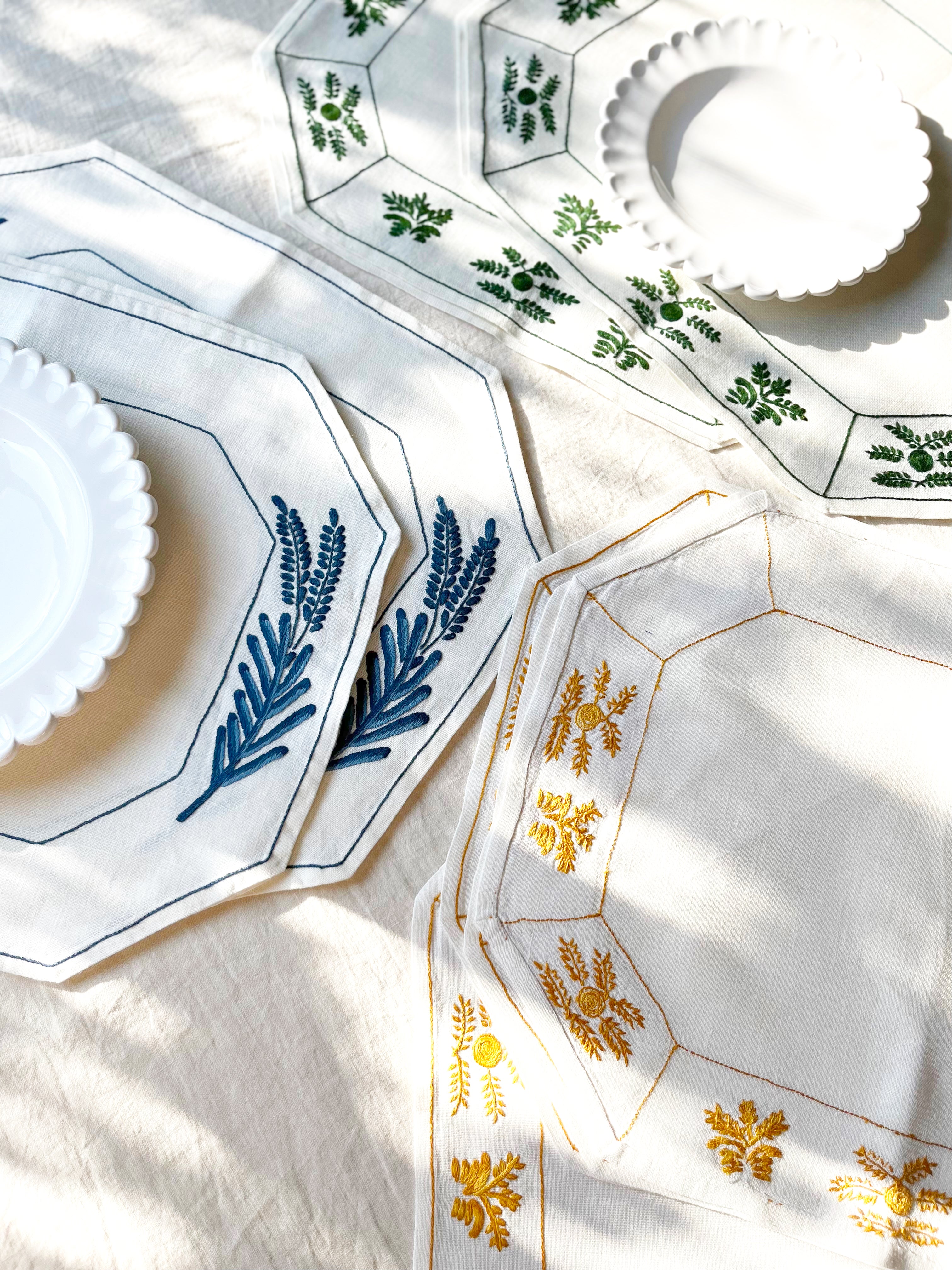 octagonal white linen placemat with olive green embroidery 19.5" by 16" with other color options