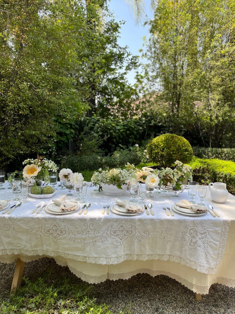 cream linen tablecloth with macrame trim on table