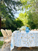 white tablecloth with blue and brown floral pattern with blue pitcher
