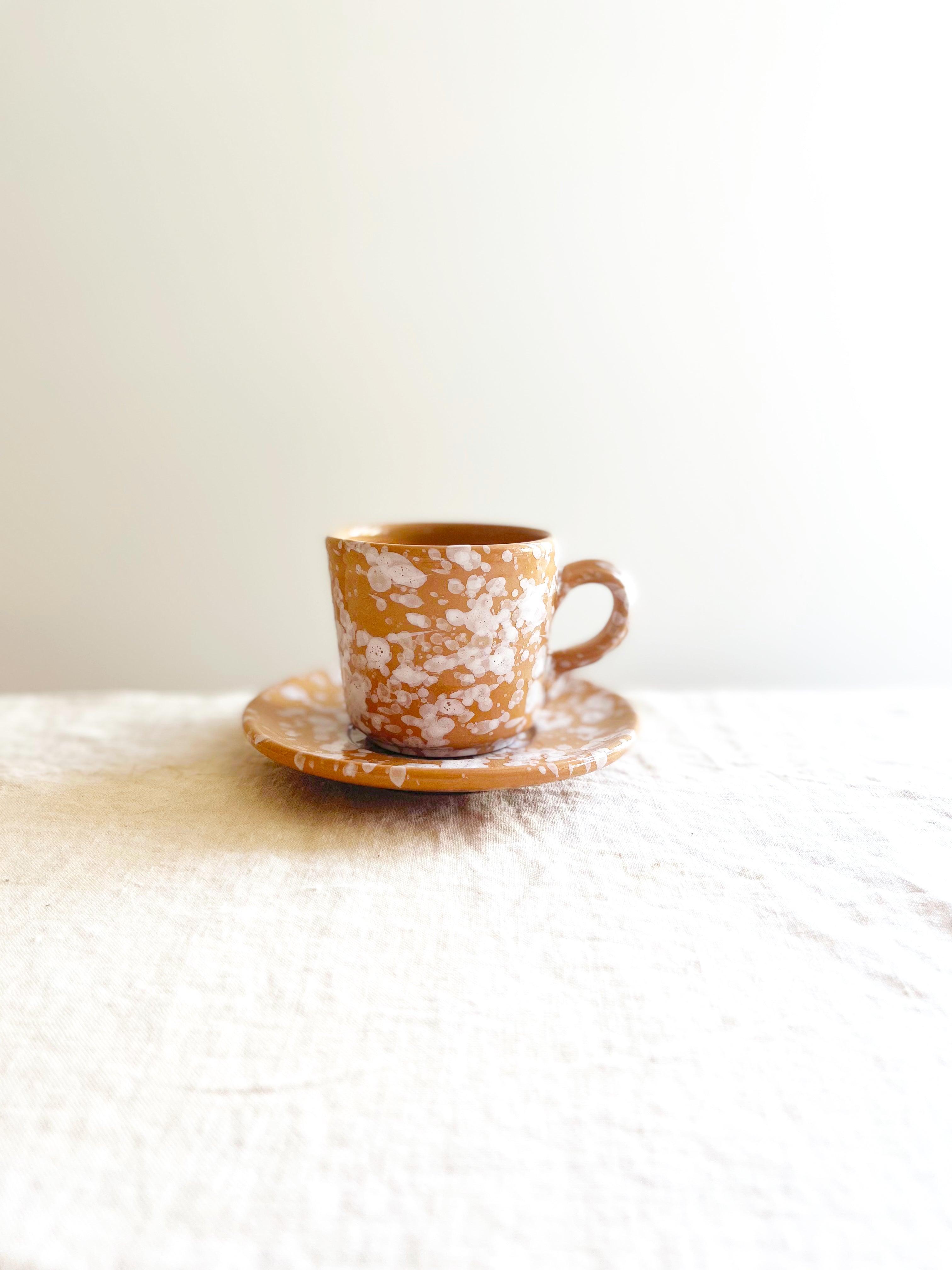 fasano espresso cups with splatter pattern in sienna on white linen cloth
