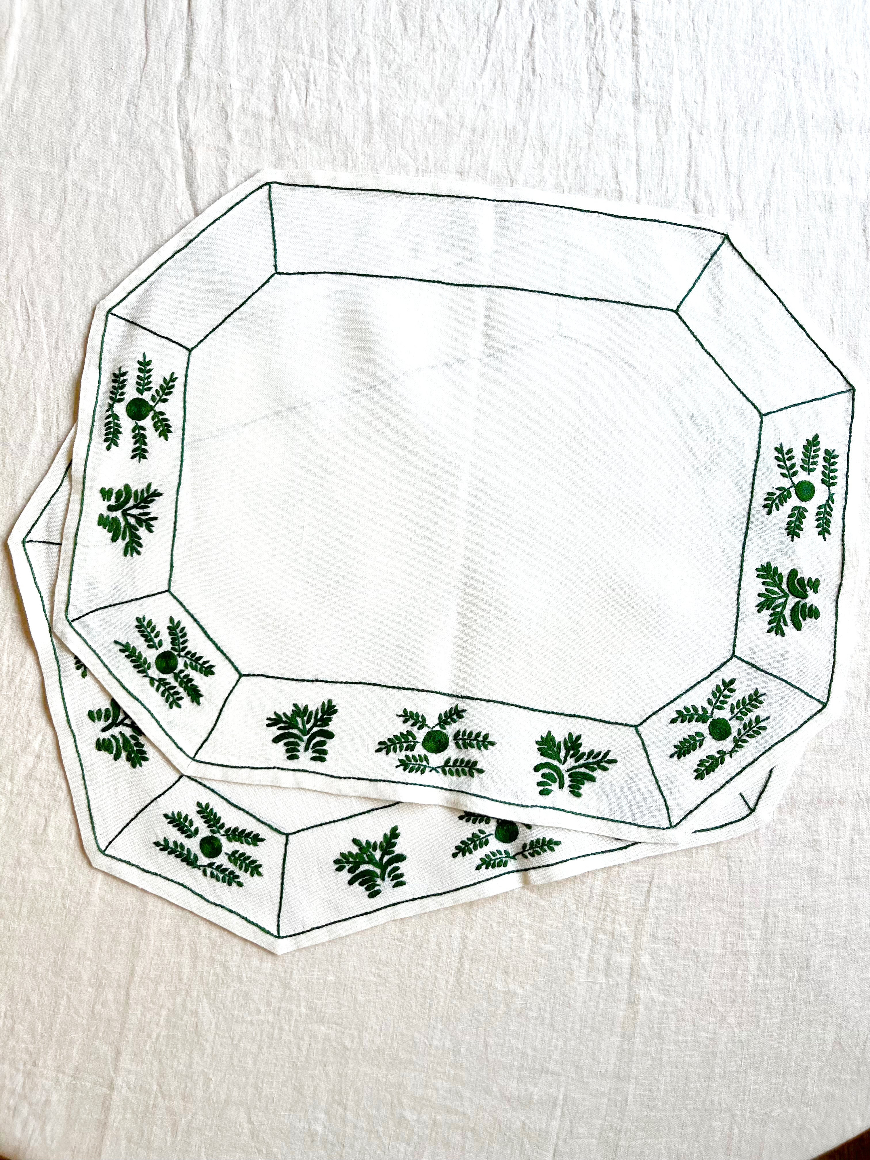 octagonal white linen placemat with olive green embroidery 19.5" by 16" group of two