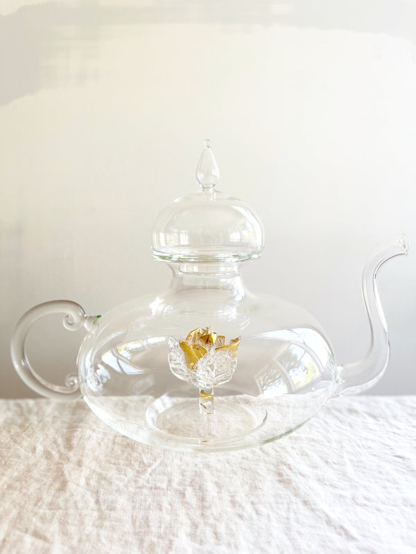 clear hand blown glass teapot with gold glass rose in bottom