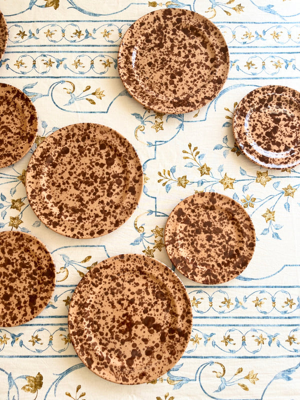 white tablecloth with blue and brown floral pattern with coco pompeii plates