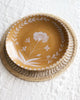 round placemat with tan floral dish
