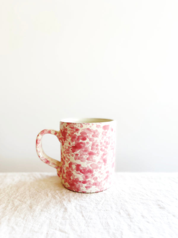 cream mug with pink splatter pattern