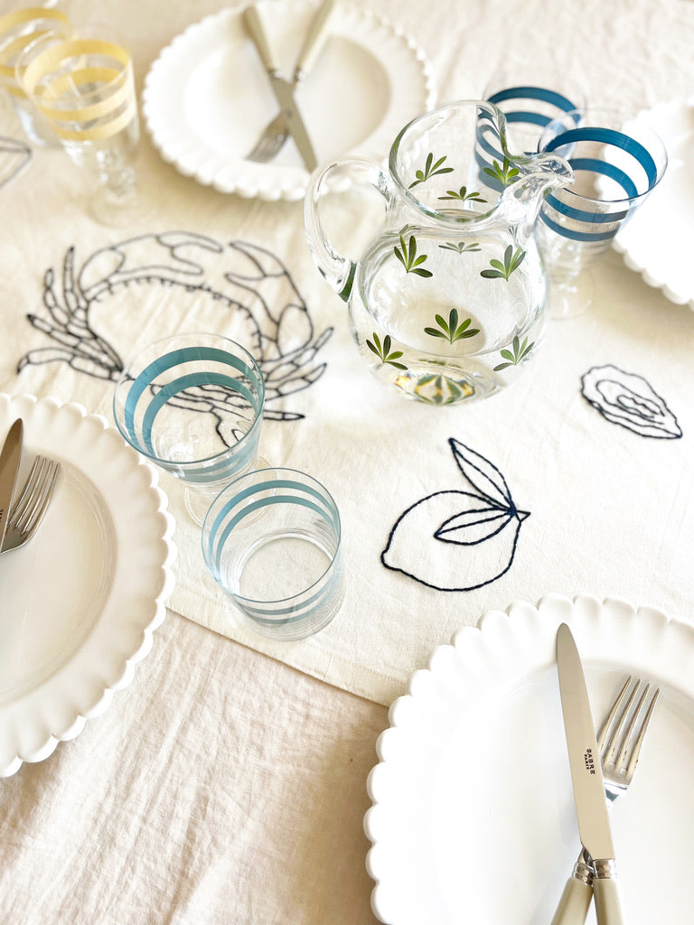 hand painted water glass with two cream stripes on table