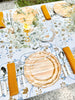 white tablecloth with blue and brown floral pattern with gold napkins