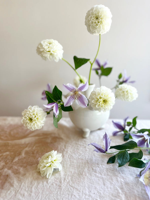 white ceramic footed tulipiere with dahlias