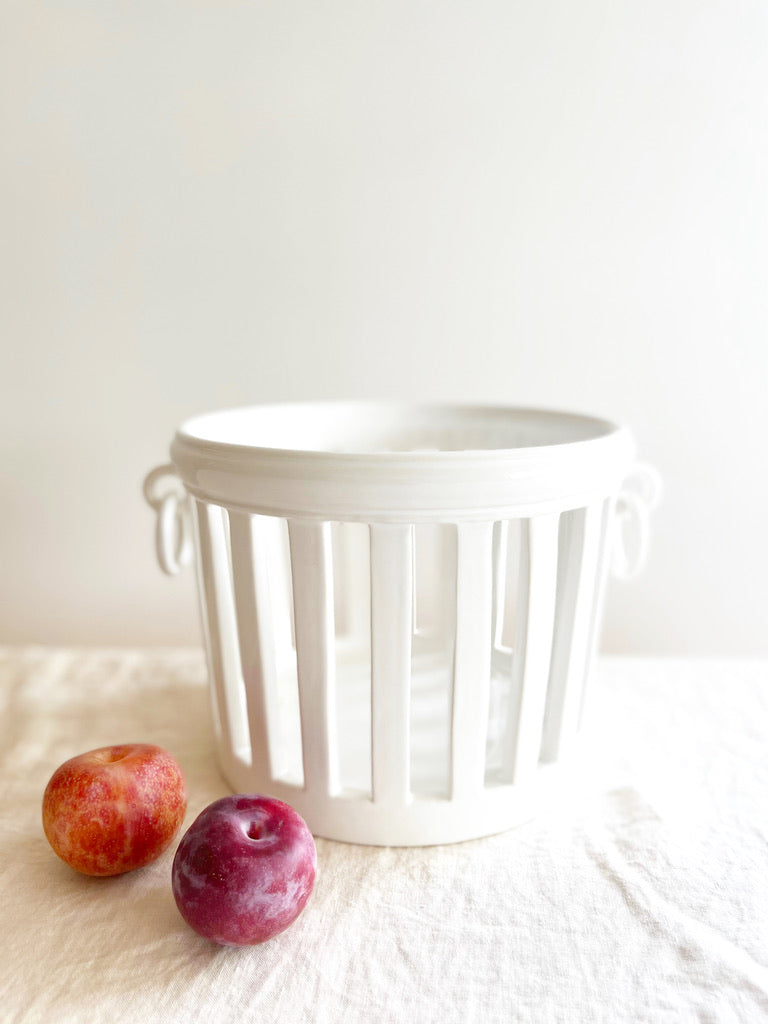 white openwork jardinere planter on table