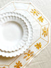 octagonal white linen placemat with gold embroidery 19.5" by 16" with white plates