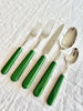 sabre stainless steel flatware set with emerald green resin handles angled view