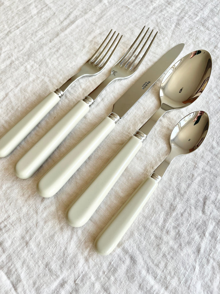 sabre stainless steel flatware set with white resin handle angle view
