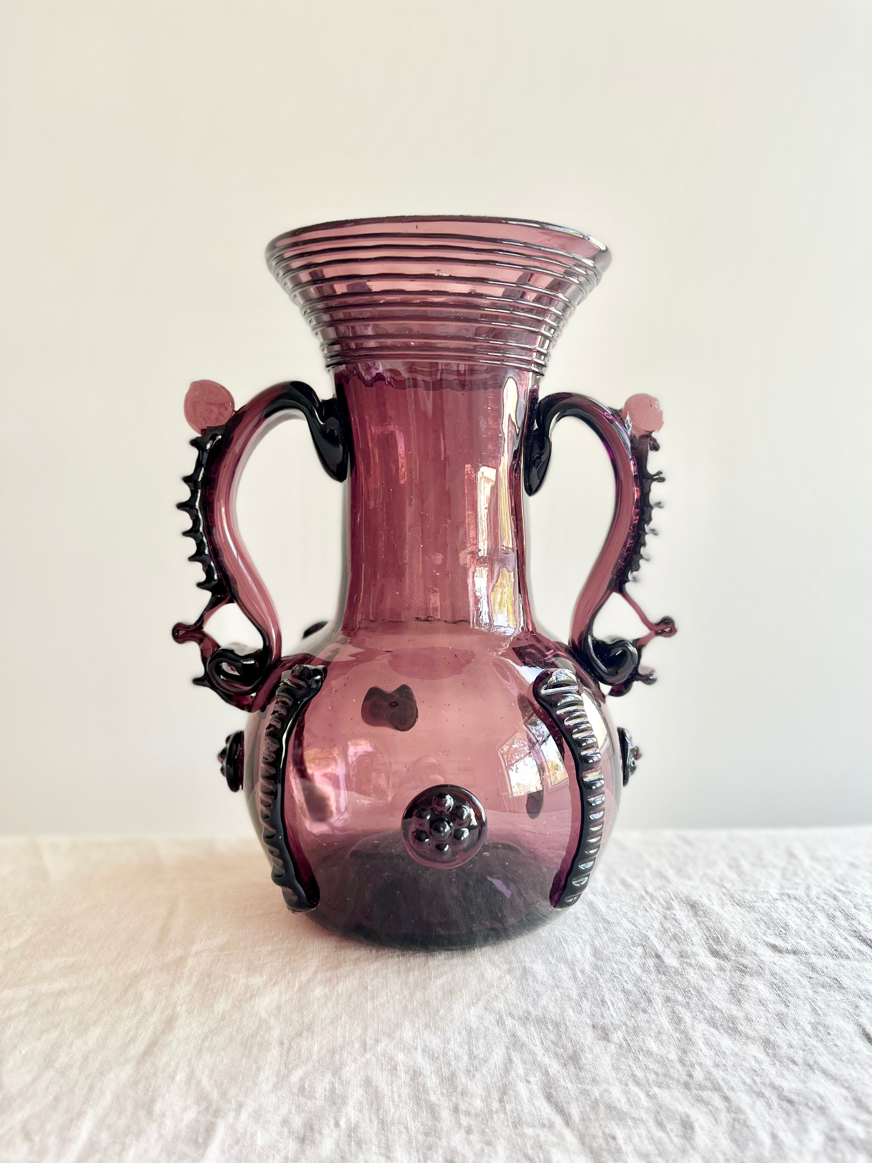 vintage plum-colored glass vase vaso petra on table