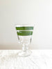 hand painted wine glass with two green stripes on white linen
