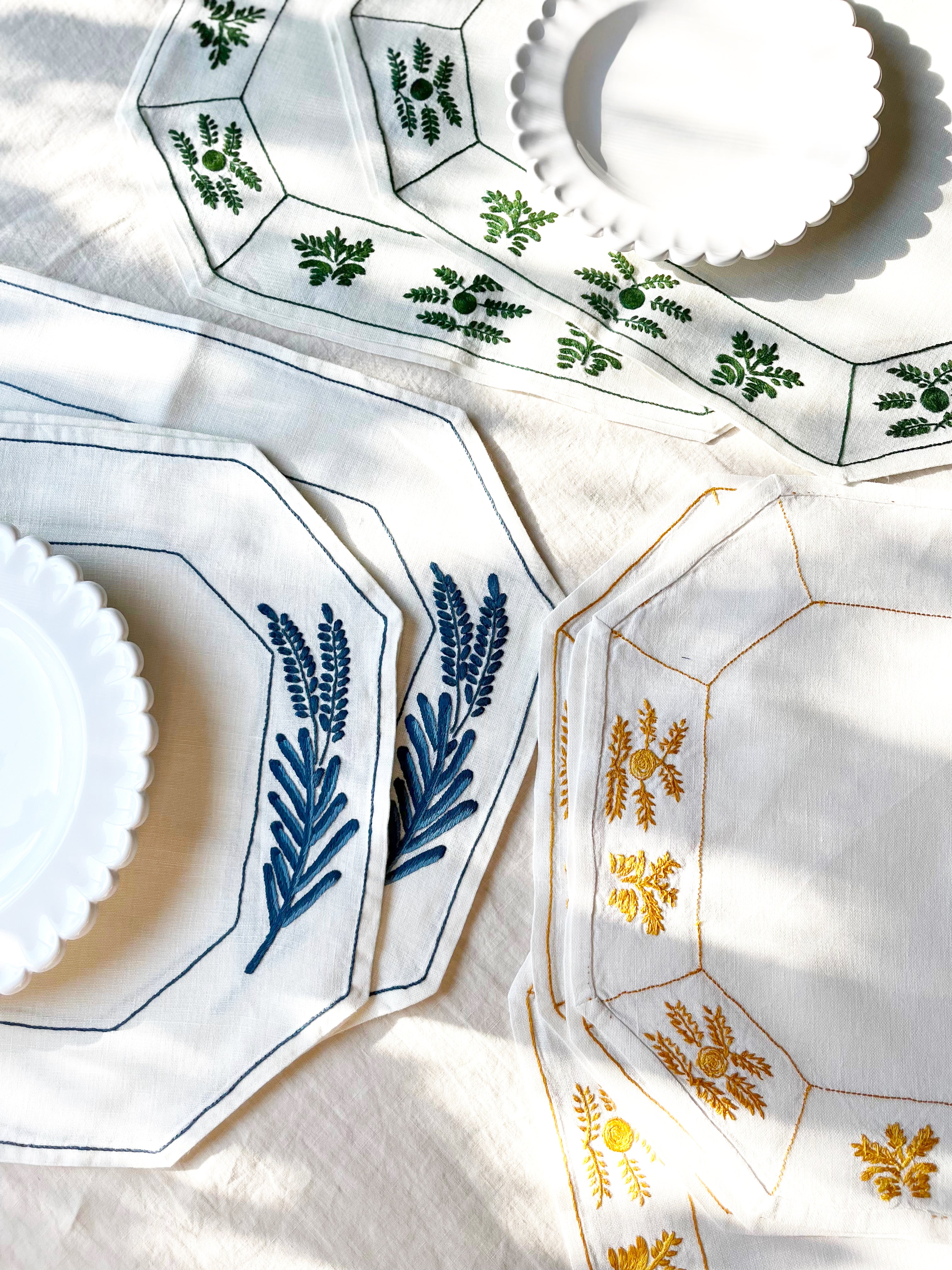 Octagonal dark blue embroidered white linen placemats assorted colors