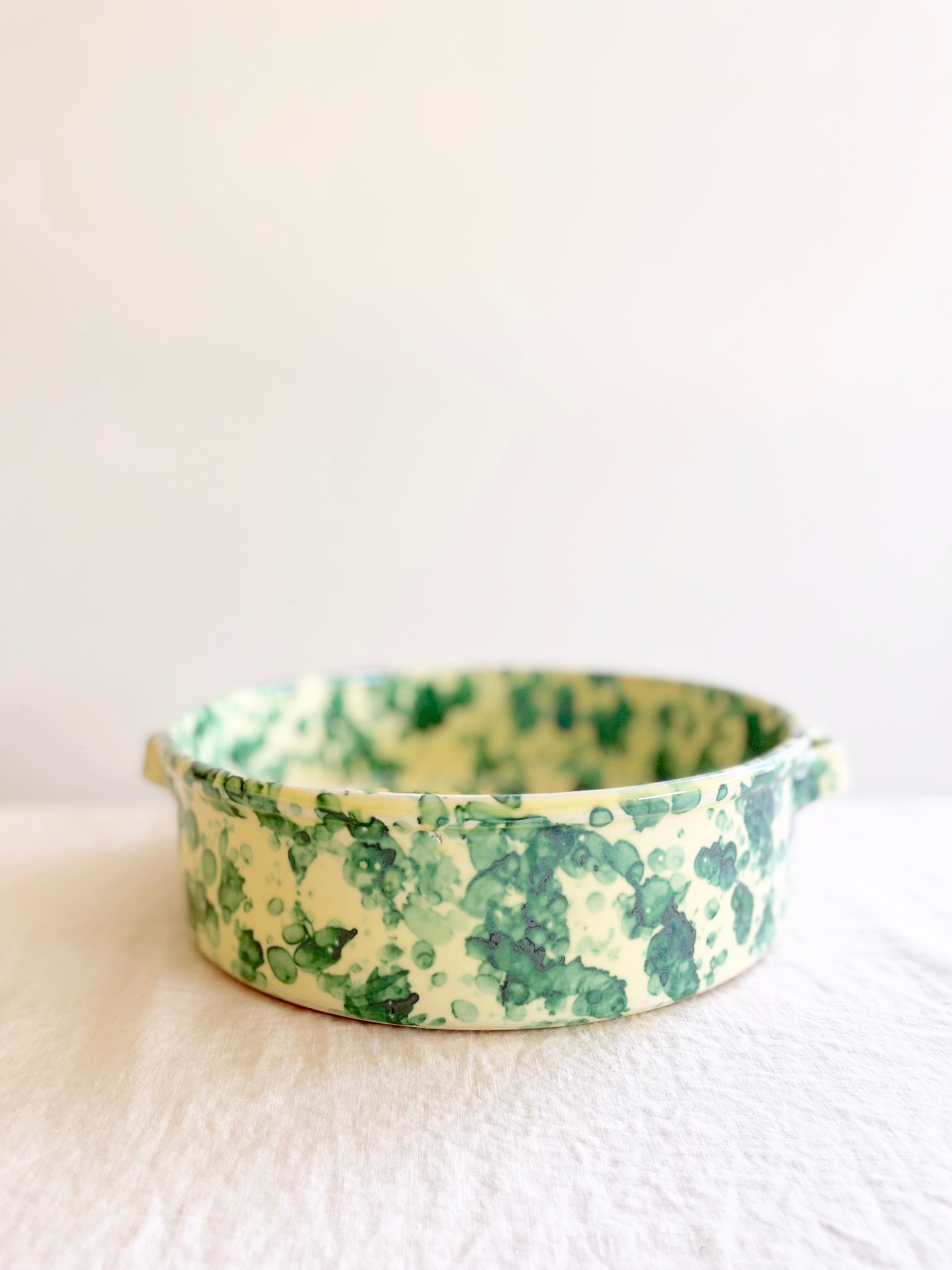 round oven safe dish in cream with green speckle pattern 11" diameter