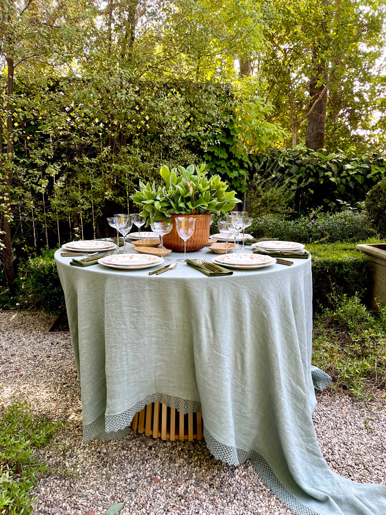 sage green linen tablecloth with macrame trim side view