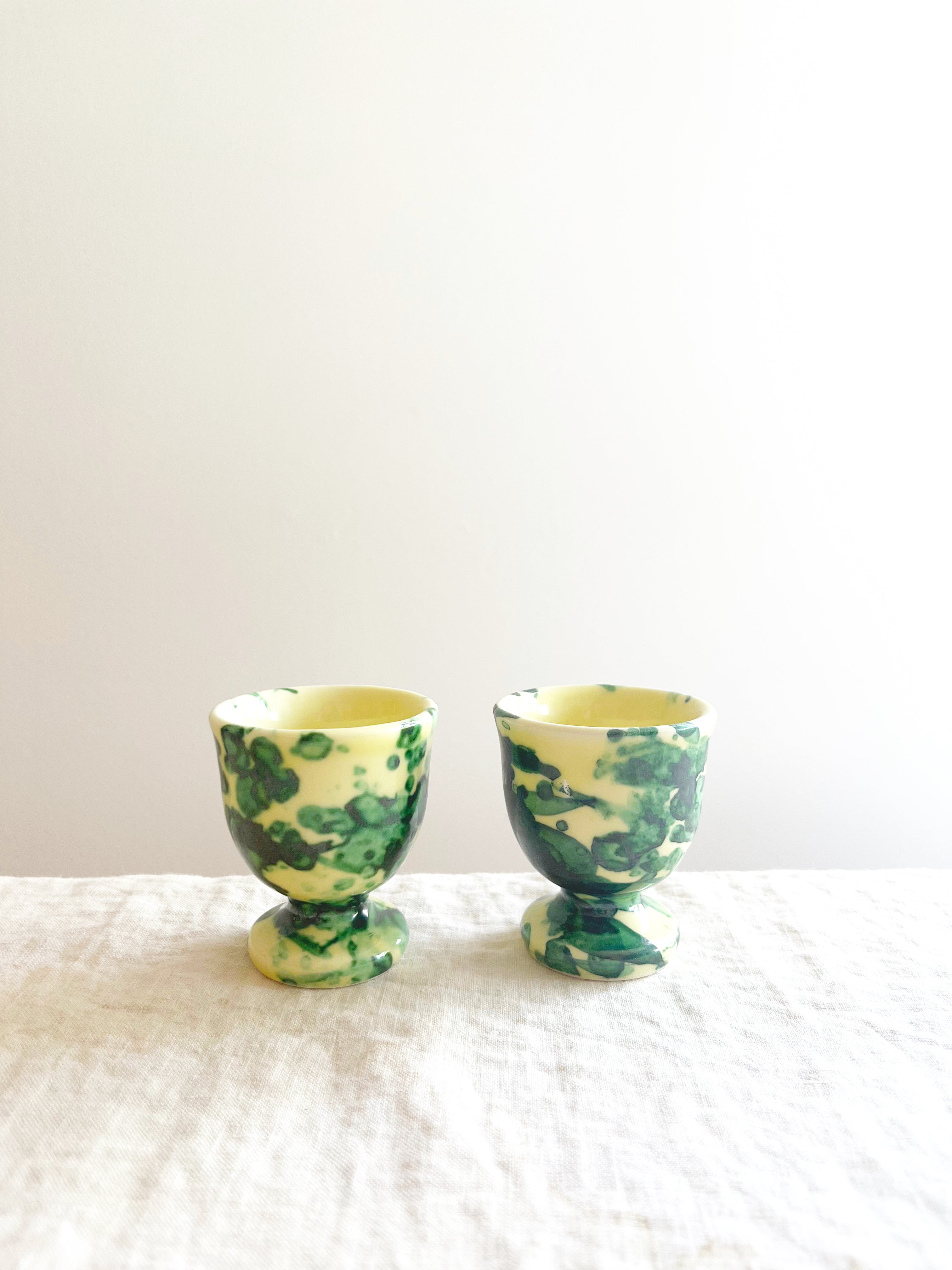 cream egg cups with green splatter pattern 2 inches in diameter