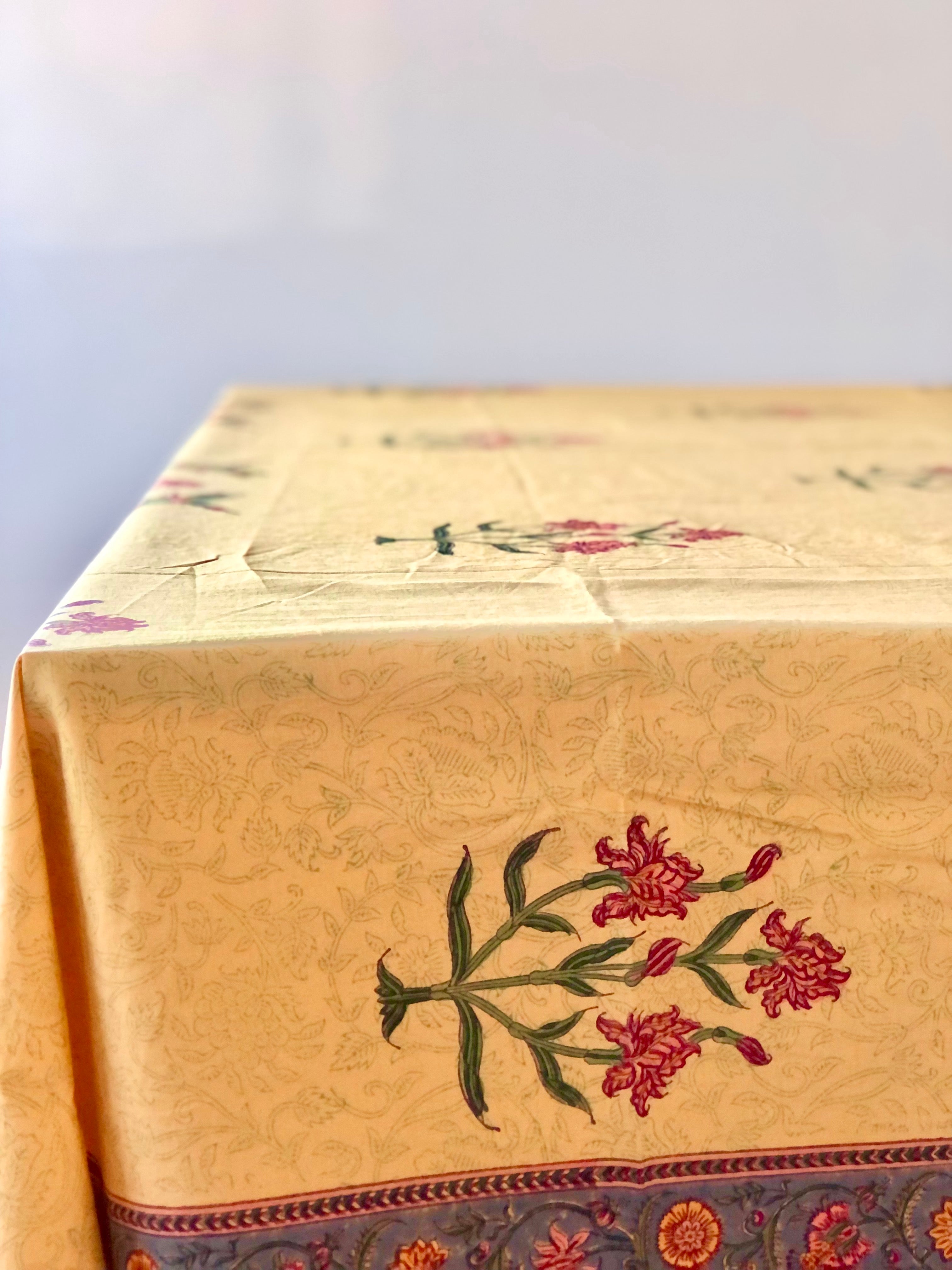 gold tablecloth with green dragonflies red irises and blue gray edge