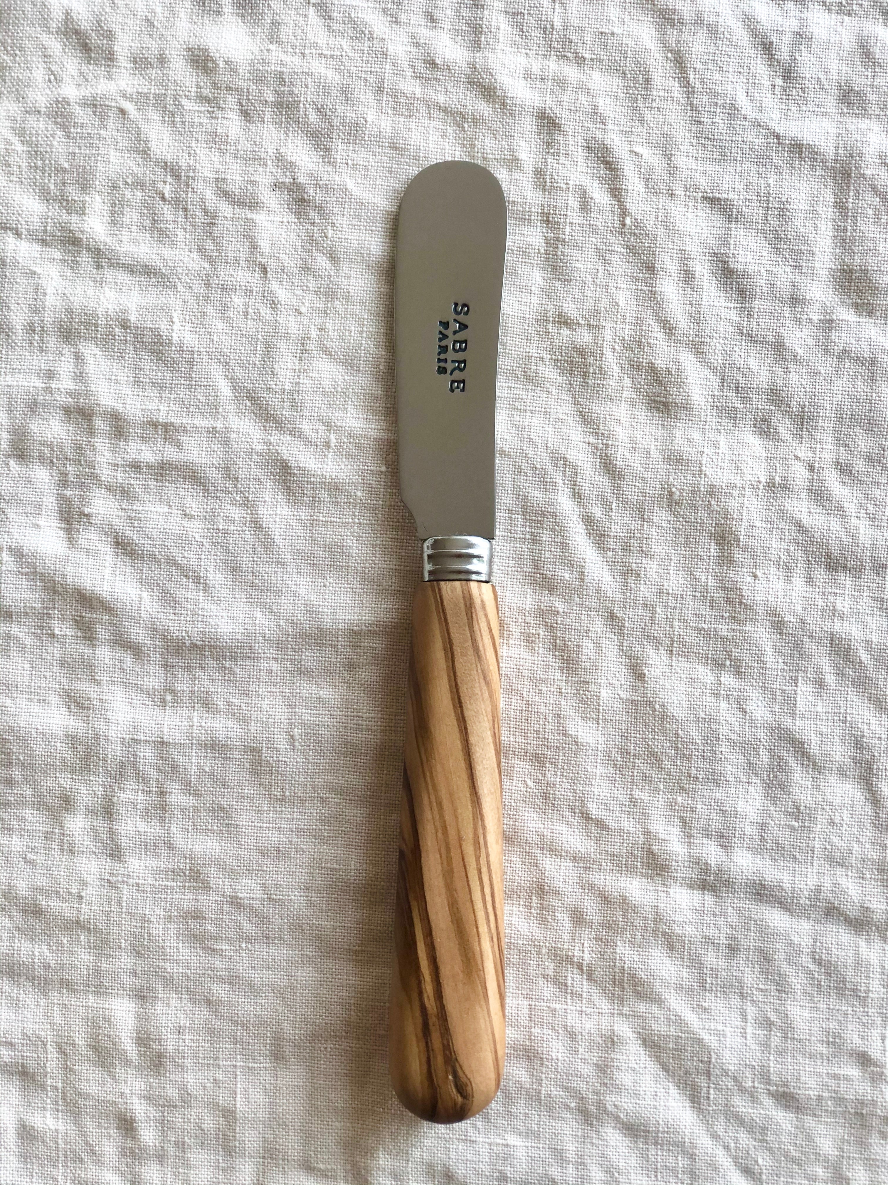 sabre stainless steel butter spreader with olive wood handles detail view