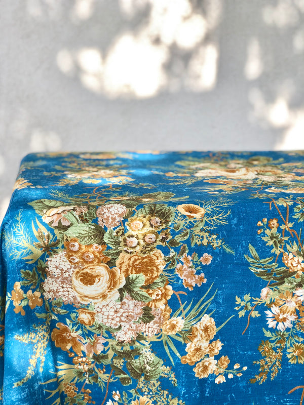 blue tablecloth with cream white and light brown floral pattern