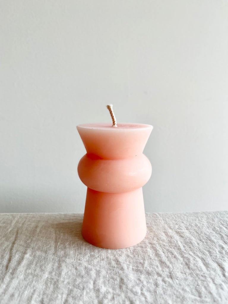small light pink peony totem candle on a table