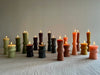assorted totem candles in green plum terra natural and pink colors
