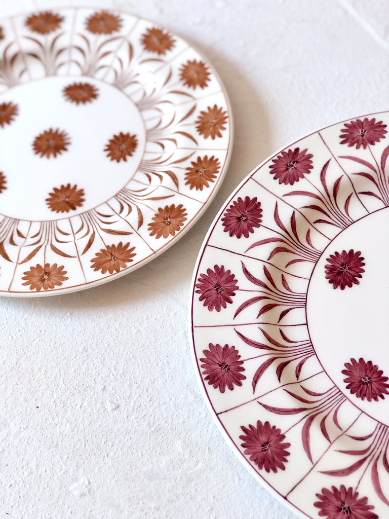 ceramic salad plate with purple daisy pattern detail of rim