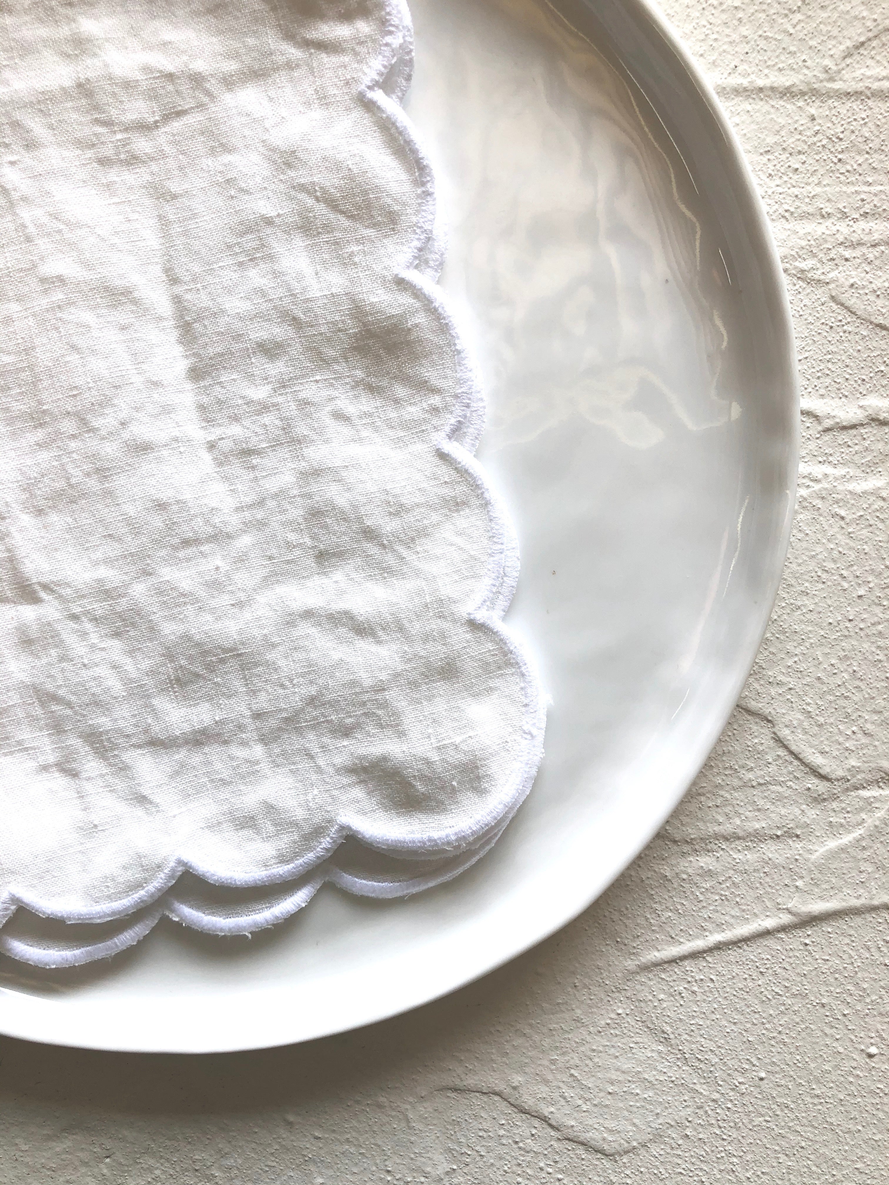 white linen linens with scalloped edge