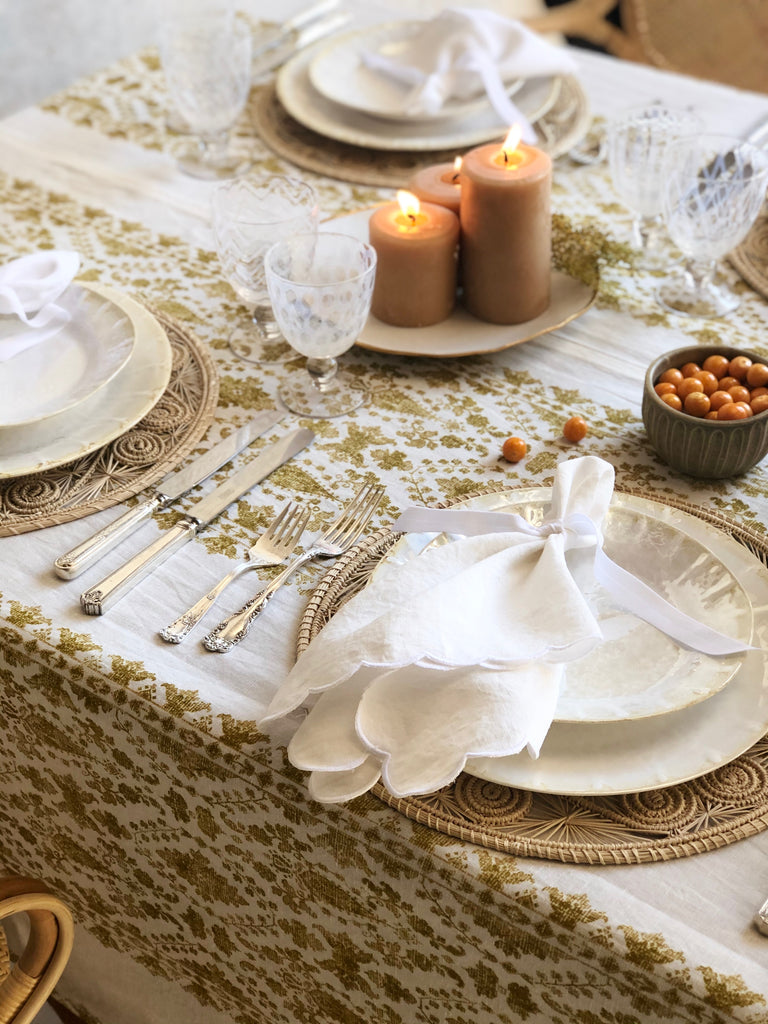 white linen linens with scalloped edge on placesetting