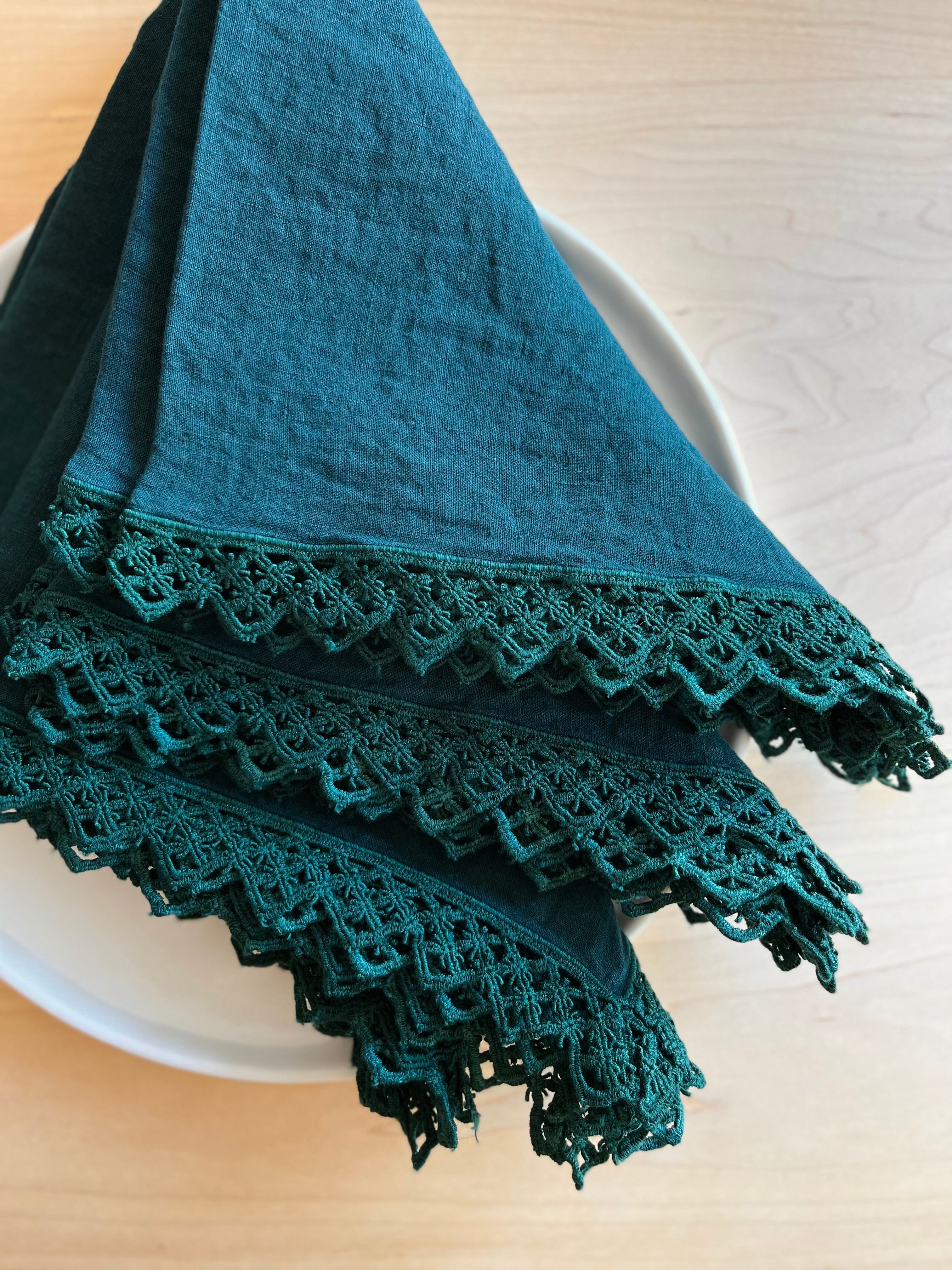 teal linen napkin with macrame trim folded