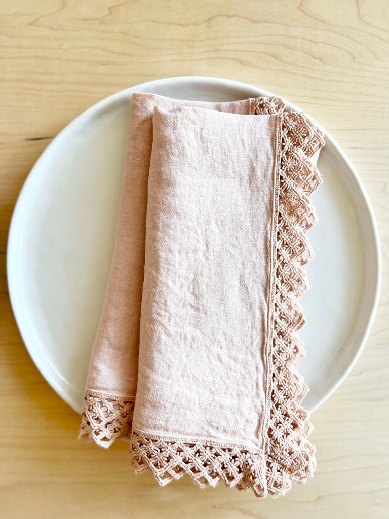 ballet pink linen napkins with macrame trim folded