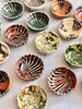 multicolor ceramic bowls group on white tablecloth 4 inches in diameter close up