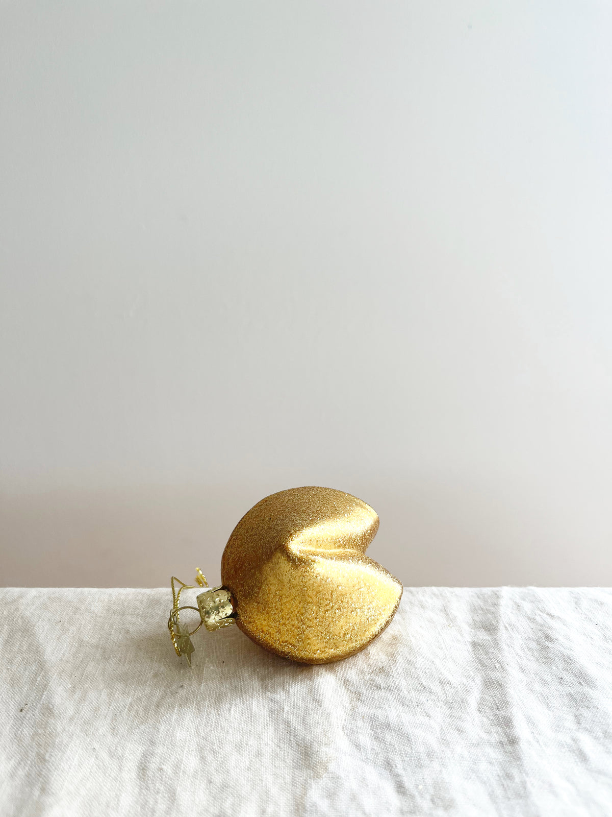 glass christmas ornament shaped like fortune cookie