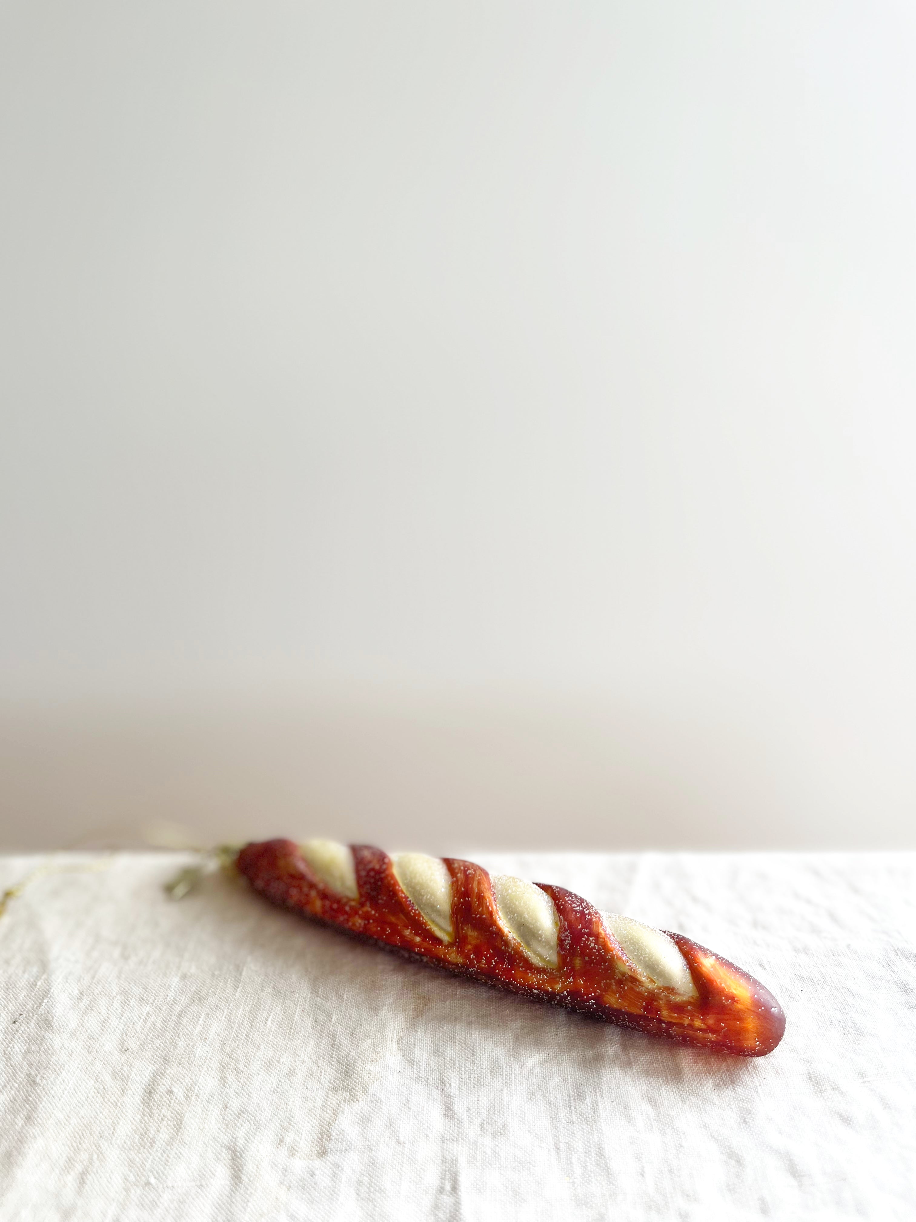 glass christmas ornament shaped like french baguette