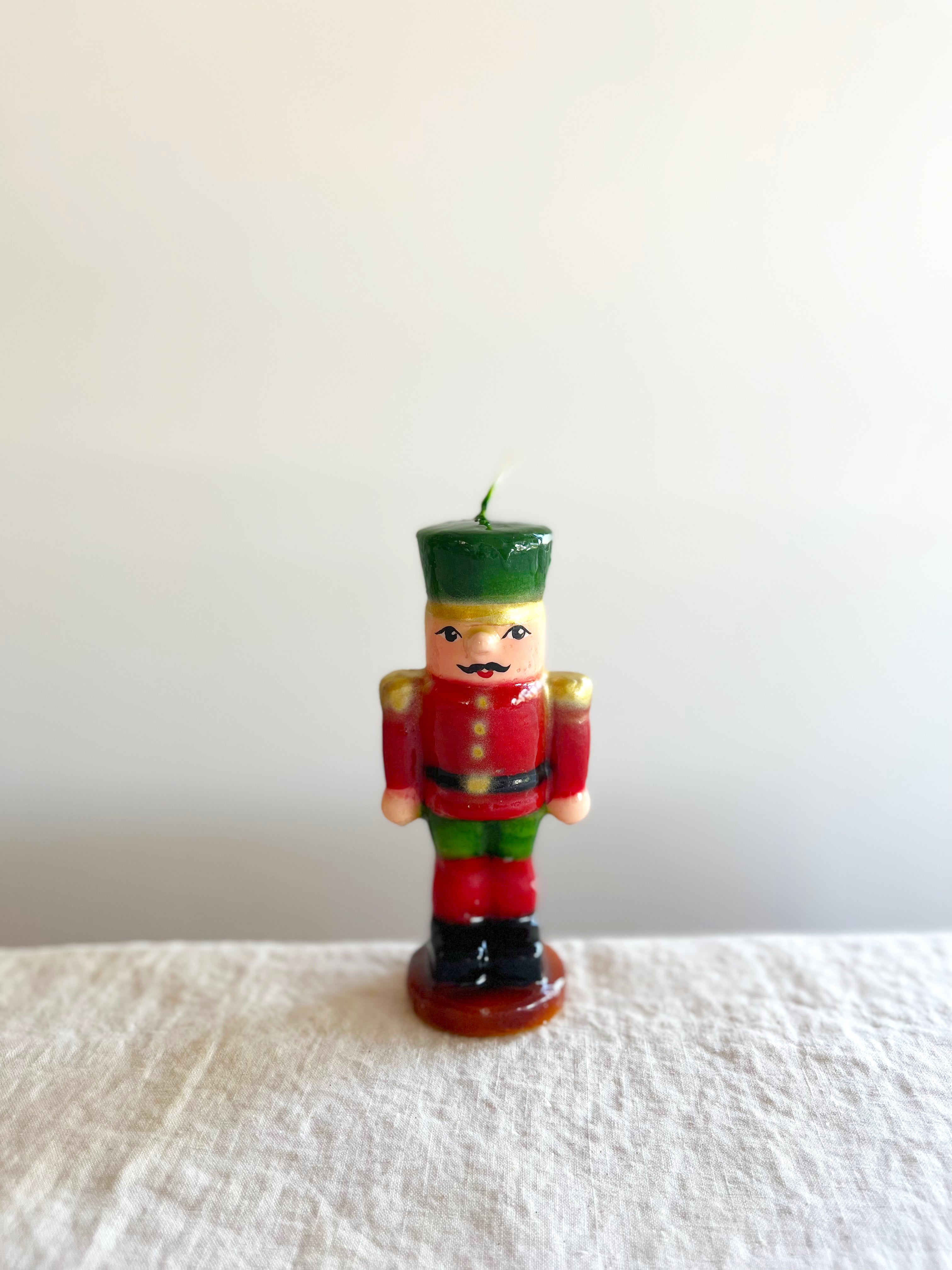 cereria introna nutcracker paraffin candle 10 inches tall on white table
