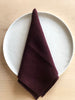 dark red rolled edge linen napkins with dark red edge 18 inch square folded on white plate