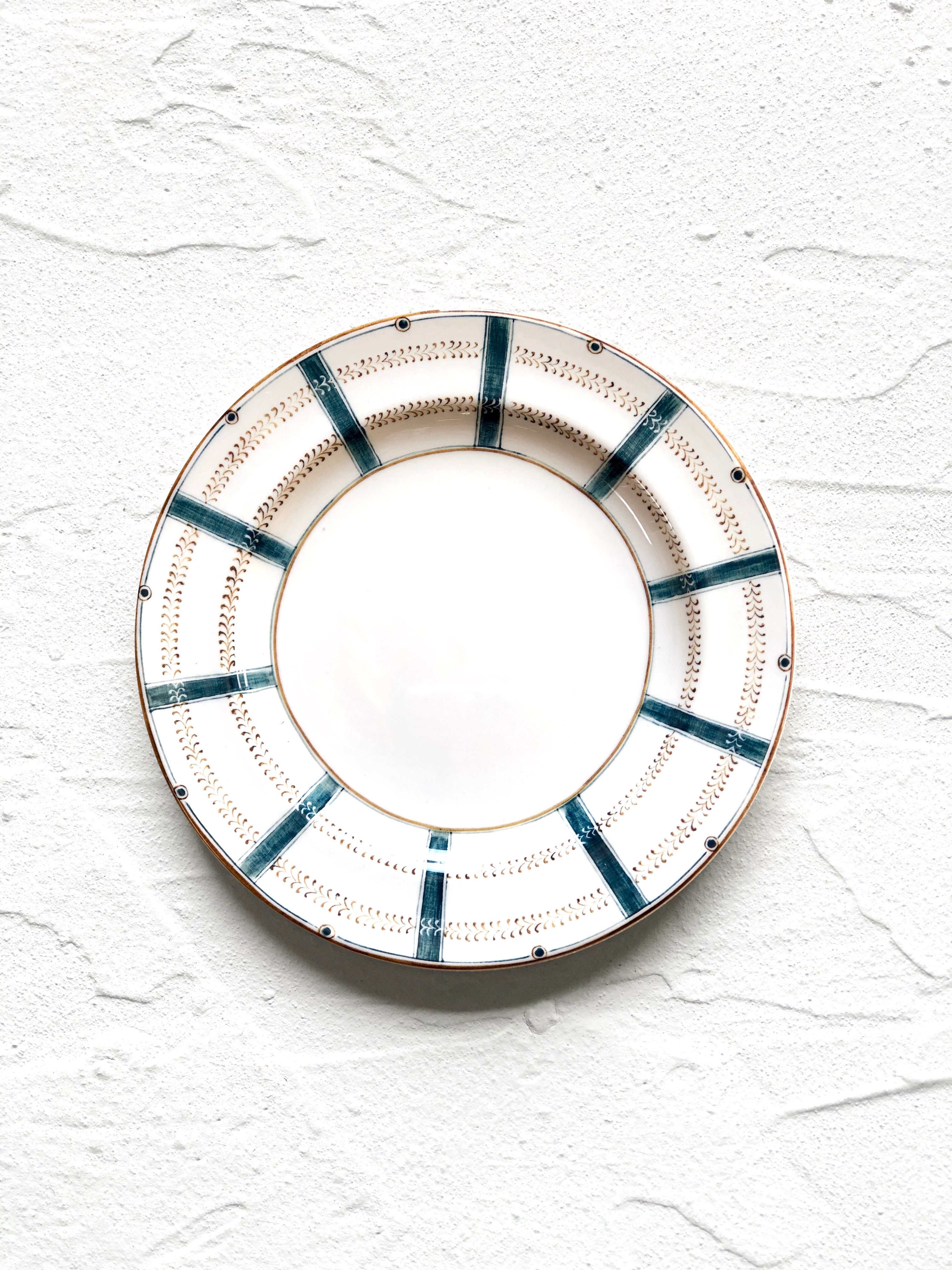ceramic salad plate with teal stripes around edge