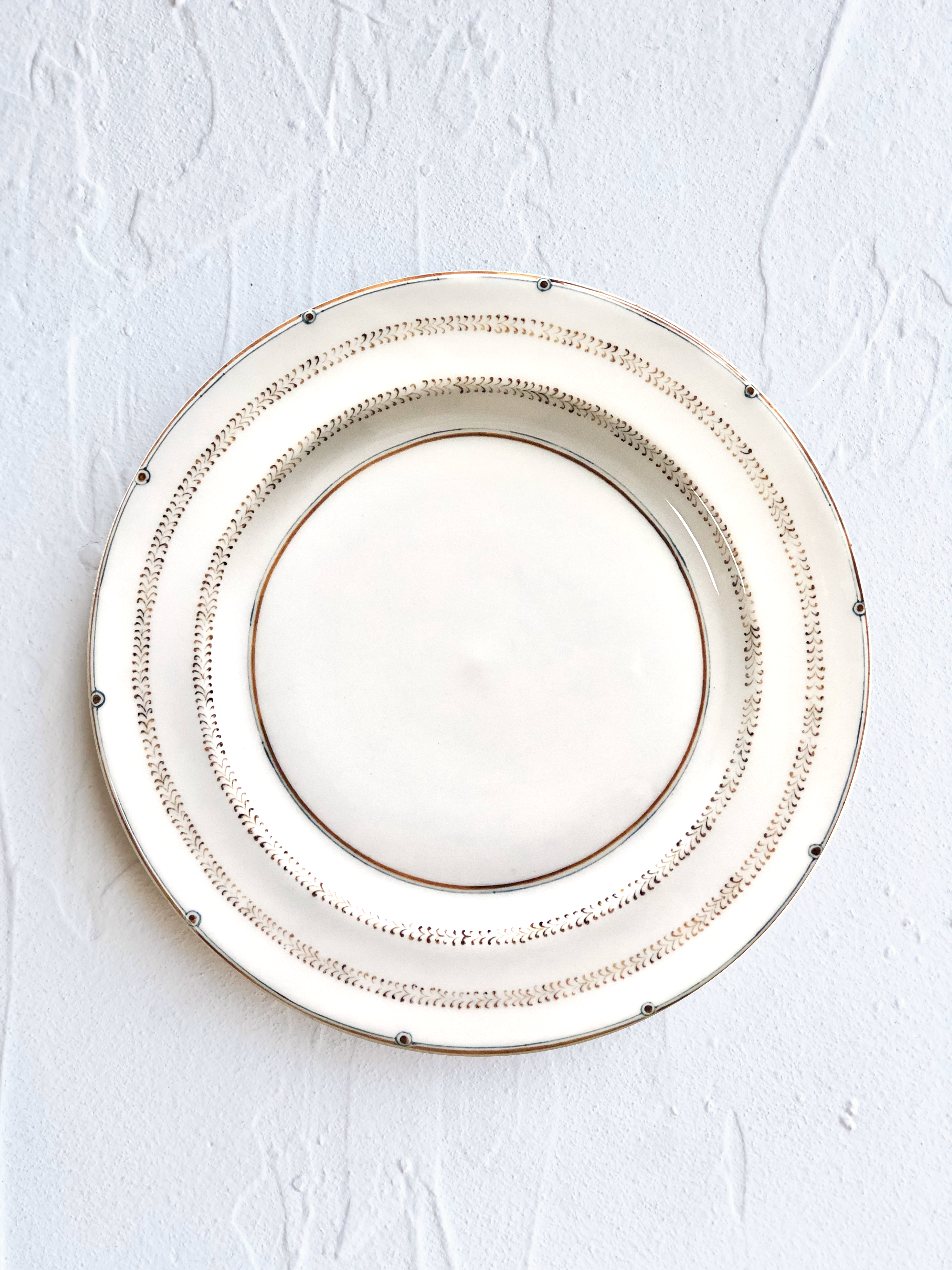 ceramic dinner plate with narrow brown brush strokes around rim