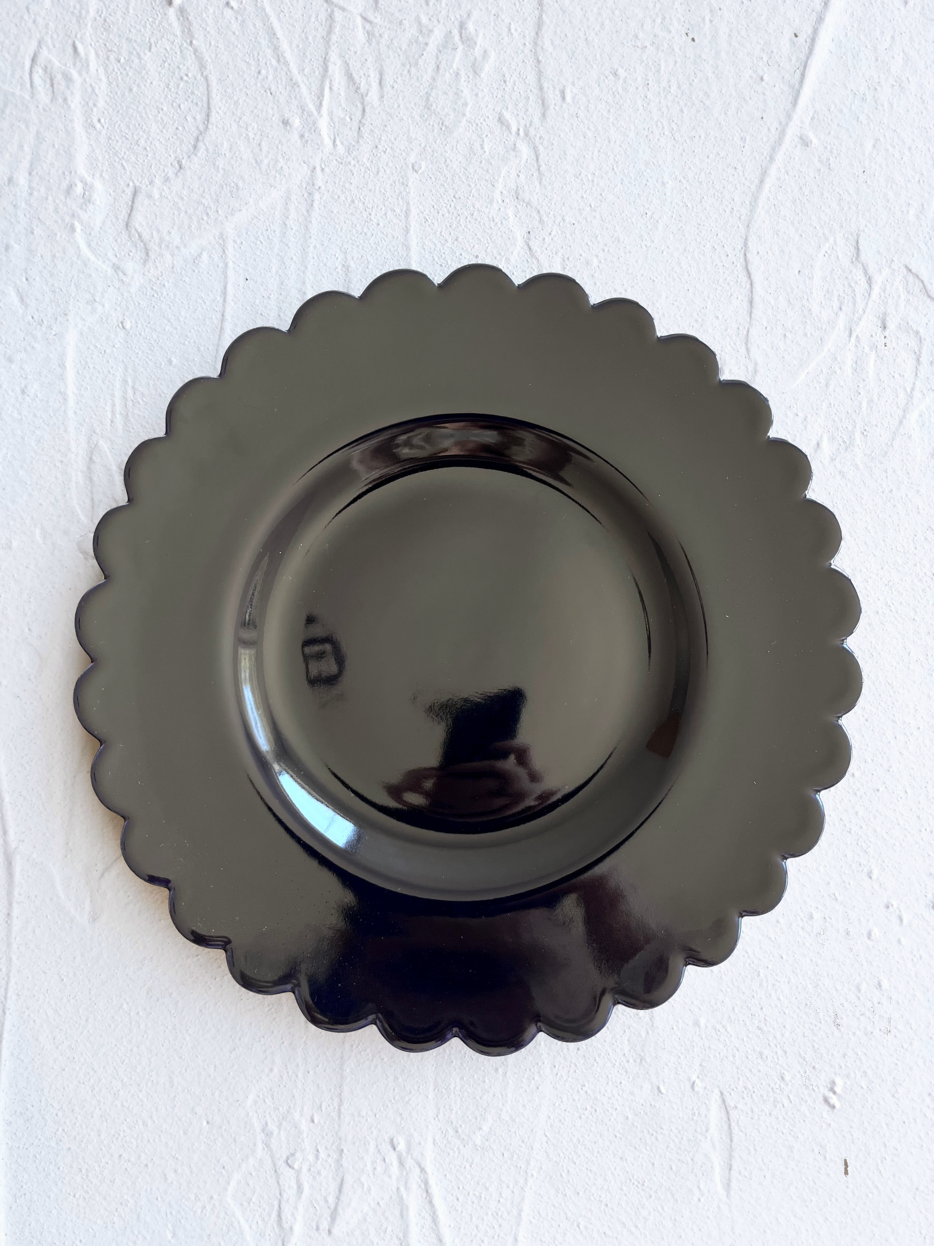 dark blue dinner plate with scalloped edge