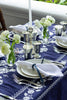 rectangular blue embroidered tablecloth with white flowers with place setting